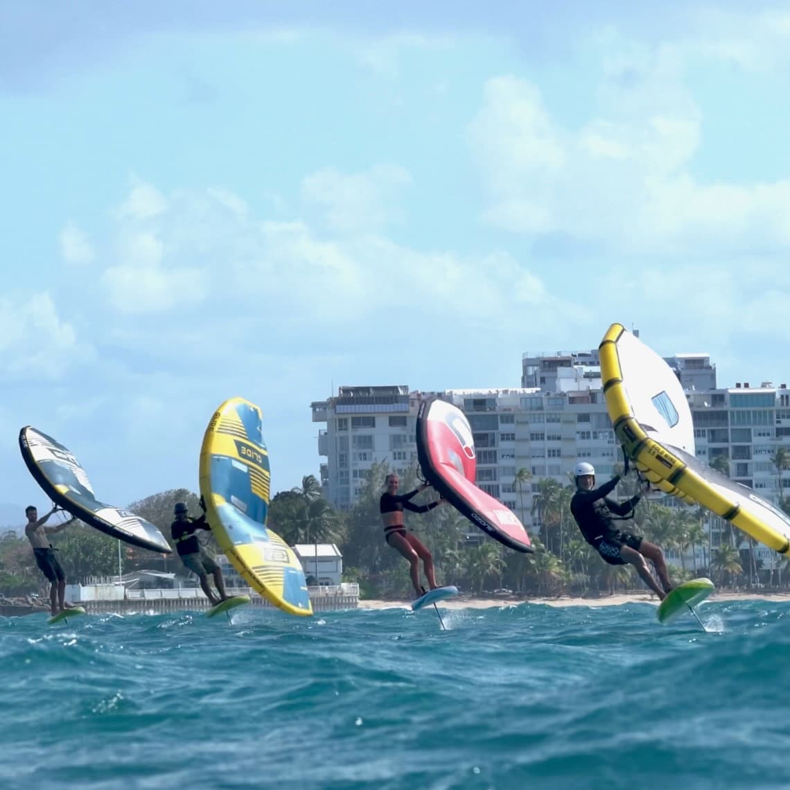 Group launching with colorful wings on a beach