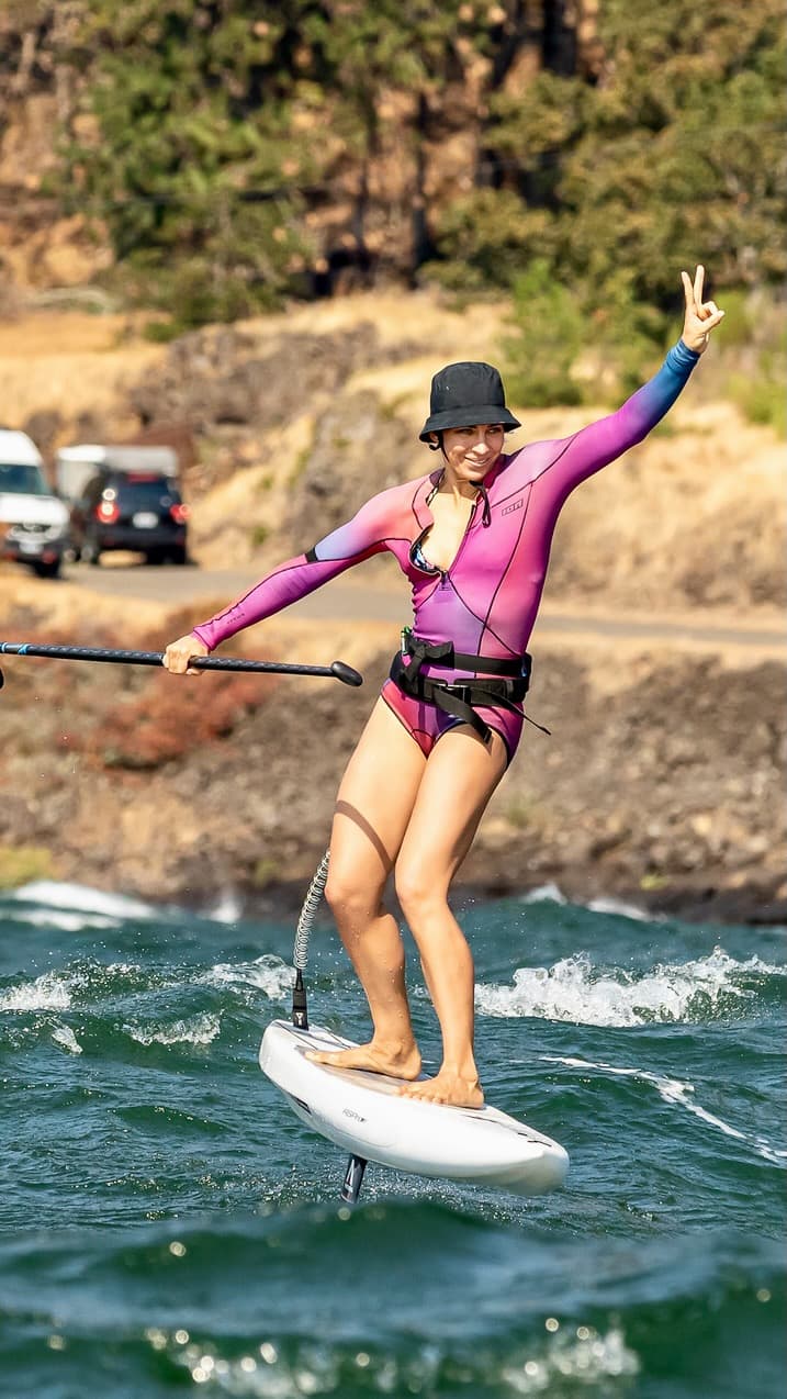 Wing foiling at the Hatchery with an arm raised